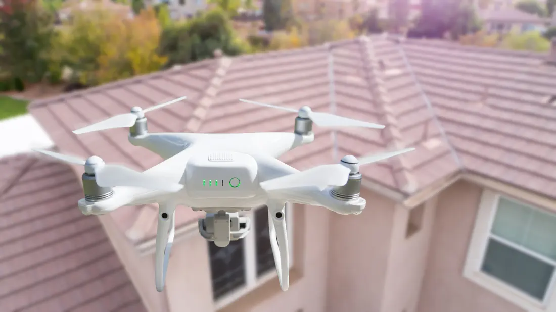 Drone conducting an aerial roof survey
